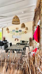 a dining room with a table and a red hat at Three Hearts in Fulhadhoo