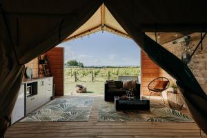 a view from the inside of a tent with a living room at Villas & Vines Glamping in Hastings