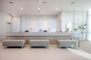 a lobby with a reception desk and two stools at Union Hotel in Seoul