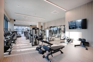 a gym with treadmills and machines in a room at Union Hotel in Seoul
