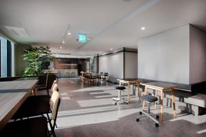 a conference room with tables and chairs and a whiteboard at Union Hotel in Seoul