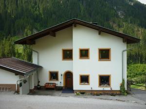 a white house with a mountain in the background at Kreidl in Tux