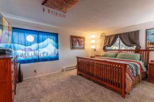 a bedroom with a bed and a large window at Winnemucca Heights in Cascade-Chipita Park