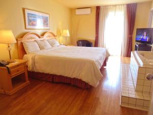 Postel nebo postele na pokoji v ubytování Hotel Alila