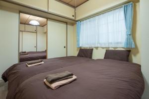 Ένα ή περισσότερα κρεβάτια σε δωμάτιο στο 札幌市中心部大通公園まで徒歩十分観光移動に便利なロケーションh205#13