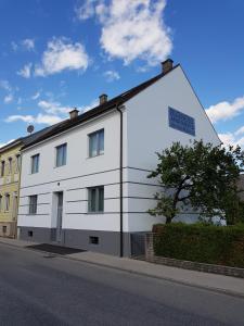 a white building on the side of a street at Apartments am Mühlbach in Amstetten