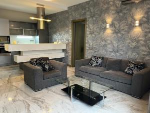 a living room with two couches and a table at Monte Carlo in Batumi
