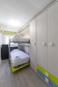a room with two bunk beds and a cabinet at Casa familiar Sabadell de 3 dormitorios junto metro Fuencarral in Madrid