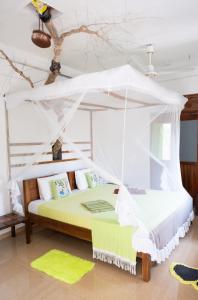 a bedroom with a bed with a canopy at Nalaka Relaxing Home in Weligama