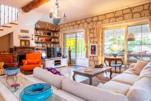 a living room with a stone wall at Luxury Duplex Villa w Pool and Garden in Alacati in Alacati