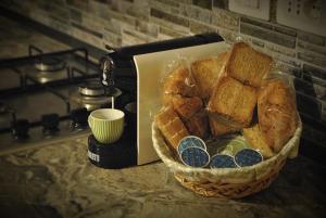 a basket of bread on a counter next to a toaster at Lime House in Lauria Inferiore +5 photos