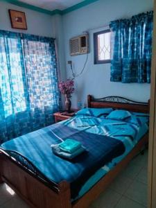 1 dormitorio azul con 1 cama grande con sábanas azules en Gallery, air-conditioned room with double bed Bathroom Toilet Pools Beaches around the corner en Gabi