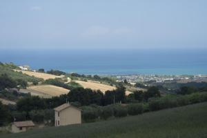 a view of a hill with a house and fields at La Casa Di Tina in Colonnella