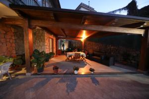 a patio with a table and a stone wall at Villa Serena in Vico Equense