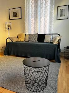 a living room with a couch and a table at Beau studio cosy et meublé Loos lez Lille, France in Loos