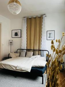 a bedroom with a bed and a window at Beau studio cosy et meublé Loos lez Lille, France in Loos