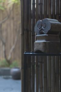 a iron fence with a mask on top of it at Manho Hotel in Taichung