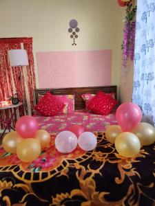 a bed with a bunch of balloons on it at Bhumi Holiday Home in Alibaug