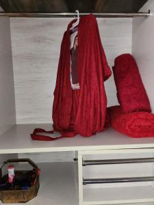 a shelf with two red pillows on it at Bhumi Holiday Home in Alibaug