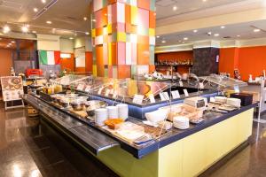 a buffet line in a restaurant with a lot of food at KOKO HOTEL Shinjuku Yotsuya in Tokyo