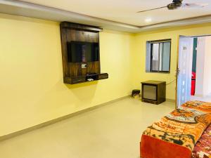 a bedroom with a bed and a flat screen tv at Hotel Treasure OF Kumbhalgarh in Kumbhalgarh