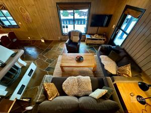 a living room with a couch and a table at Large cabin at Sjusjøen with sauna, fireplace, view and cross-country skiing in Ringsaker