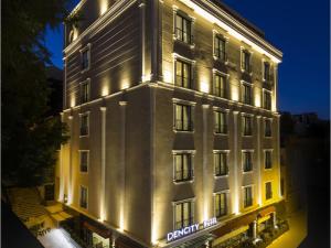 a large white building with lights on it at Dencity Hotels & Spa in Istanbul