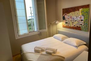 滨海博利厄Appartement Baous 300m de la mer - Happy Rentals的卧室里有一张床，床上放着两条毛巾。