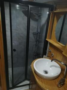 a bathroom with a shower and a white sink at cemal efe in Fethiye