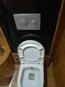 a bathroom with a white toilet with the seat up at cemal efe in Fethiye