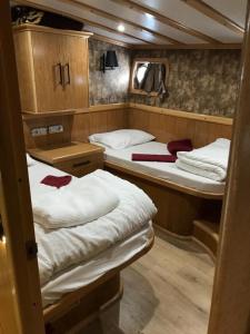 two beds in a small room in a boat at cemal efe in Fethiye