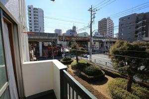 a balcony of a building with a view of a city at Edogawa Japanese Style Apartment 202 has direct access to Akihabara and Shinjuku, with convenient transportation and free WiFi in Tokyo