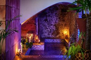 a room with purple and purple lights on a wall at Dormsy aparthotel House in Arenys de Mar