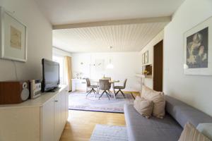 ein Wohnzimmer mit einem Sofa und einem Tisch in der Unterkunft Brentschpark 28 in Scuol