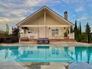 a house with a swimming pool in front of a house at Quinta de Argos in Cehegín