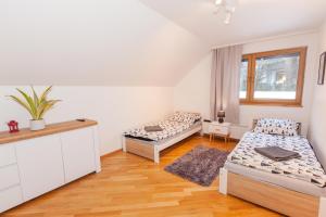 a bedroom with two beds and a table at Dom Na Wrzosowej in Szczyrk
