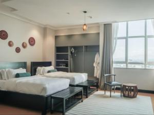 A bed or beds in a room at Sanna Boutique Hotel