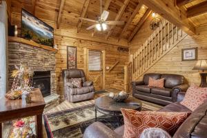 a living room with leather furniture and a fireplace at Whispering Creek #302 in Pigeon Forge