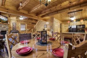 a dining room with a table in a cabin at Whispering Creek #302 in Pigeon Forge