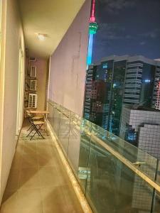 a balcony with a view of a city at night at LILA SUITES ONE BUKIT CEYLON in Kuala Lumpur