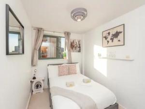 a small bedroom with a bed and a window at Pass the Keys City Centre Retreat close to Christmas Markets in Leeds