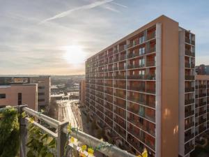 a tall apartment building with the sunset in the background at Pass the Keys City Centre Retreat close to Christmas Markets in Leeds