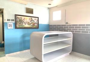 uma cozinha com um frigorífico branco num quarto em OYO 90252 Penginapan Wahee em Kuala Terengganu