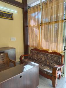 a living room with a couch and a table at Royal Comforts in Mysore