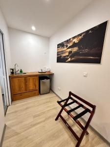 a room with a table and a chair in it at Ononui Lodge Airport, Ocean-View, Private Bathroom and Balcony, Free WiFi and Parking, On-Site Car Rental in Faaa