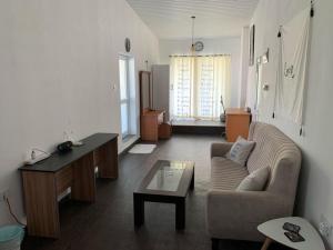 a living room with a couch and a table at My place Sri Lanka Apt Near Airport (CMB) in Katunayake