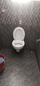 a bathroom with a white toilet in a stall at Triumph inn Bhubaneswar in Bhubaneshwar