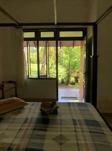 a room with a bed and a large window at Candle House in Kalutara North