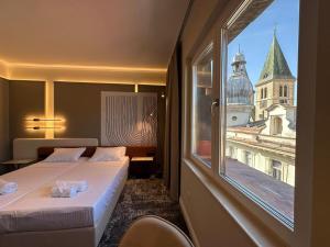 a hotel room with two beds and a large window at The Place 87 in Sarajevo