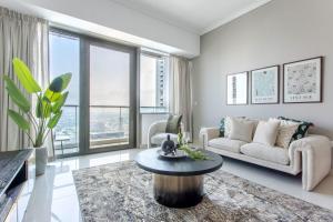 a living room with a couch and a table at Frank Porter - Ocean Heights in Dubai